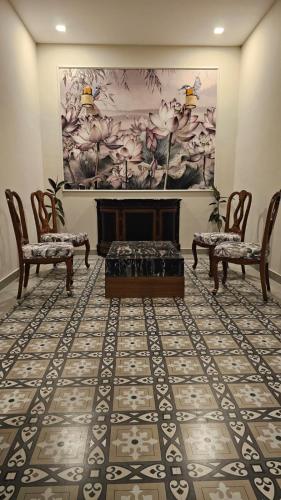 a living room with two chairs and a fireplace at Srina Vilas, Corbett in Rāmnagar
