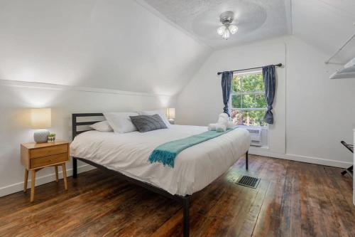 a bedroom with a large bed and a window at Raptor Retreat Family in Drumheller