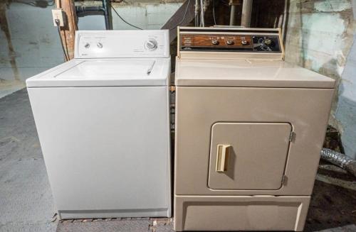 a stove and refrigerator sitting next to each other at Raptor Retreat Family in Drumheller