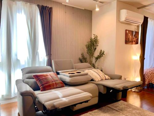 a living room with a couch and chairs in it at Monzennakacho Royal Residence in Tokyo