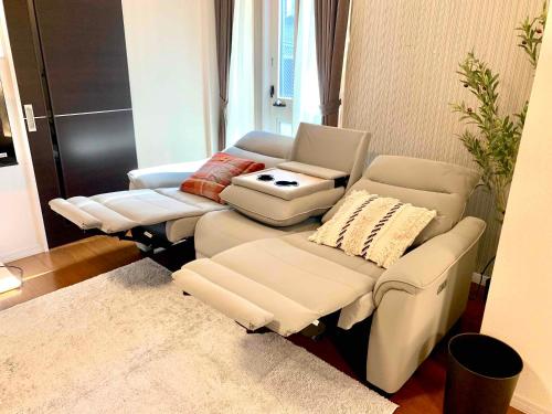 a living room with two couches and a table at Monzennakacho Royal Residence in Tokyo