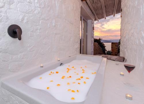 a bath tub with gold coins inside of it at Enso Botanico Boutique Villa, Kosmos in Hartbeespoort