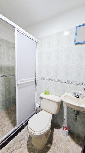 a bathroom with a toilet and a sink at Mom's House Colombia Casa 2 in Cali