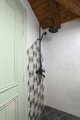 a bathroom with a light hanging from a wall at Robolo Boutique Hotel by H&T in Litochoro