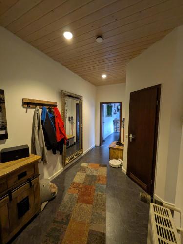 a room with a hallway with a door and a room with a unintention at Luxus Ferienwohnung Troisdorf in Troisdorf