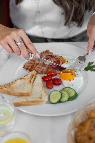a plate of breakfast food with eggs and toast at Kurhotel Brussel in Františkovy Lázně