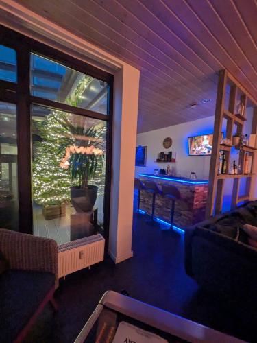 a living room with a large window and a pool at Luxus Ferienwohnung Troisdorf in Troisdorf