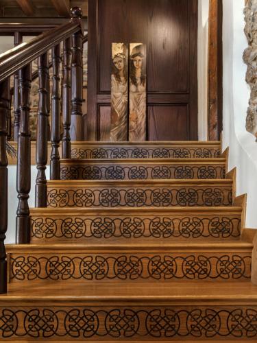 two statues of two women on the stairs of a house at Robolo Boutique Hotel by H&T in Litochoro