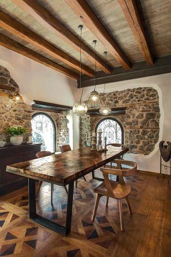 a dining room with a large wooden table and chairs at Robolo Boutique Hotel by H&T in Litochoro