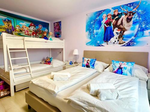 a bedroom with two beds and a disney mural at Mese Panzió Zalakaros in Zalakaros
