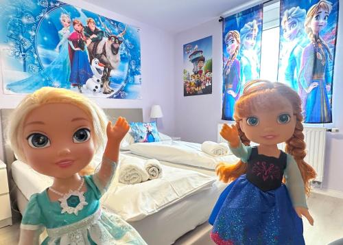 two dolls standing in front of a hospital bed at Mese Panzió Zalakaros in Zalakaros