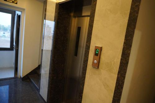 a elevator in a building with a sign on the wall at Hotel The Royal Barbariq in Khātu
