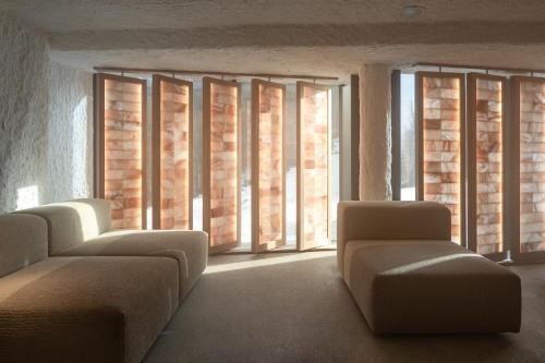 a room with a row of windows with couches at Mountain Residence Wellness & SPA in Bukovel