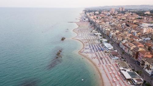 an aerial view of a beach with umbrellas and crowds at Amarena Vacanze in Porto Recanati