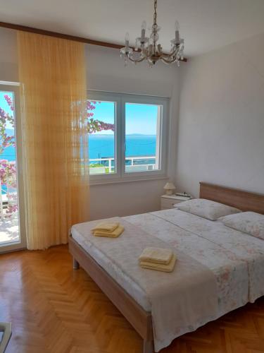 a bedroom with a bed with a view of the ocean at EmTo Suhi Potok in Jesenice
