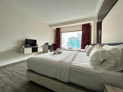 Кровать или кровати в номере Kingston Hotel by Minsu