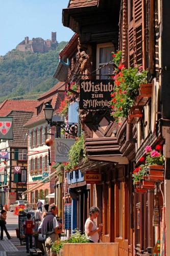 a group of people walking down a city street at La Poulie - Apartment with Balcony and Free Privative Parking - Close to Colmar in Sainte-Croix-en-Plaine