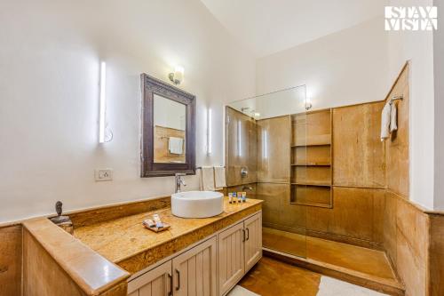 a bathroom with a sink and a mirror at 5bhk Luxurious Heritage Villa La Bougainvillea with Pvt Pool, Bathtub, BBQ at Porvorim in Porvorim