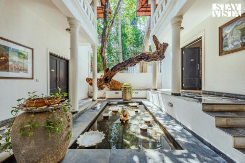 a room with a fish pond in the middle of a house at 5bhk Luxurious Heritage Villa La Bougainvillea with Pvt Pool, Bathtub, BBQ at Porvorim in Porvorim