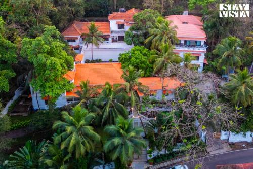 an aerial view of a resort with palm trees at 5bhk Luxurious Heritage Villa La Bougainvillea with Pvt Pool, Bathtub, BBQ at Porvorim in Porvorim