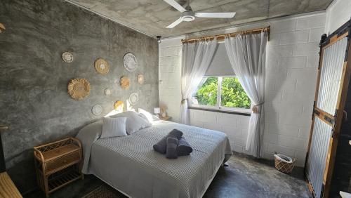 a teddy bear sitting on a bed in a bedroom at Kot Nou - Kwizine Mama Manze Lakaz in Mahébourg