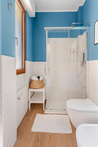 a bathroom with a white toilet and a shower at TheKeyStudio, Stella Marina Suite in Bordighera
