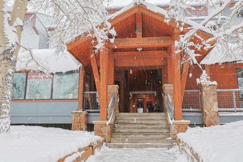 a building with a staircase in the snow at Copper Junction Studio Loft CJJD in Copper Mountain