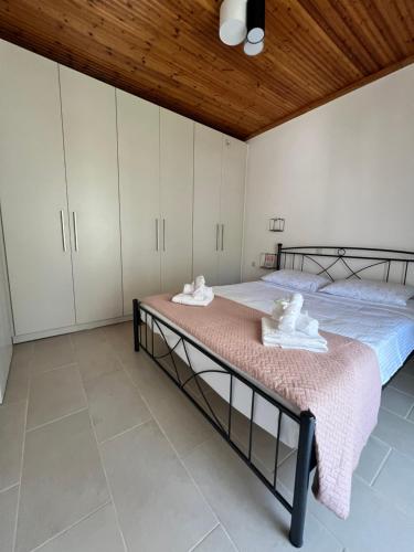 a bedroom with two beds and white cabinets at Kampos View in Ágios Nikólaos