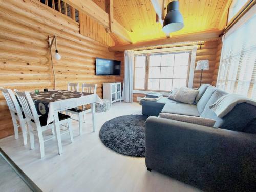 a living room with a couch and a table at Holiday Home Honkakoli 1 in Kolinkylä