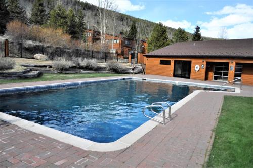 a swimming pool in a yard with a house at Tennis Townhome 2 Bd 25 Ba TTMR in Keystone