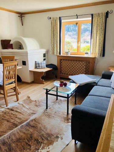a living room with a couch and a table at Landhaus Feller in Reith bei Kitzbühel