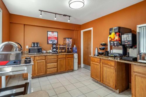 a kitchen with orange walls and a coffee shop at Econo Lodge Hays I-70 in Hays