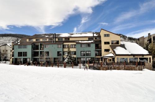 a large building with snow on the ground in front at Fox Pine Lodge Hotel Room 2 FPAFH2 in Copper Mountain