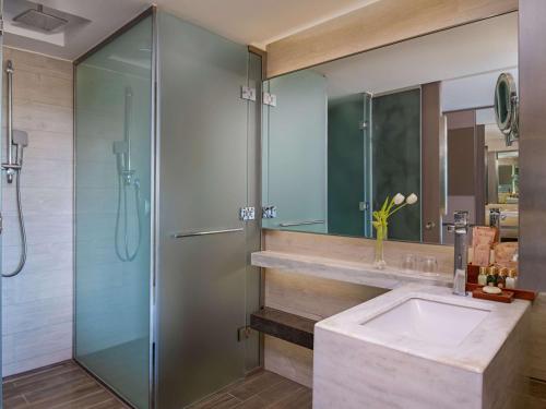 a bathroom with a sink and a shower at Rixos Premium Tekirova - The Land of Legends Access in Tekirova