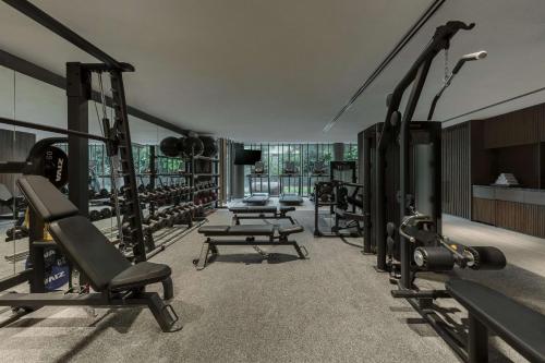 a gym with rows of treadmills and machines at Mandai Rainforest Resort by Banyan Tree in Singapore
