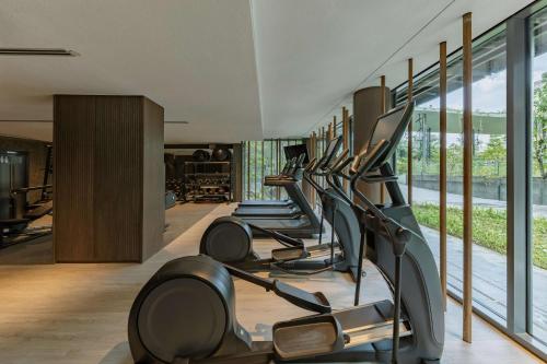 a row of exercise bikes in a fitness room at Mandai Rainforest Resort by Banyan Tree in Singapore