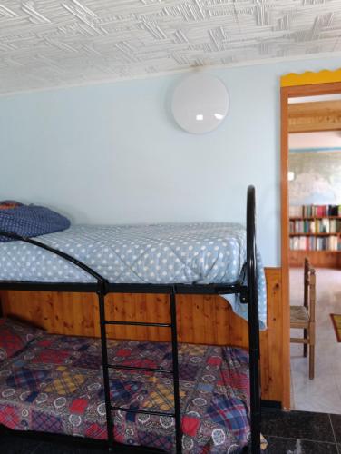 a room with a bed and a chair in a room at Casa Beatrice in Spilimbergo