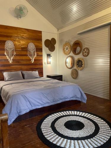 a bedroom with a large bed with a large spiral carpet at Balla Naila in Gili Trawangan