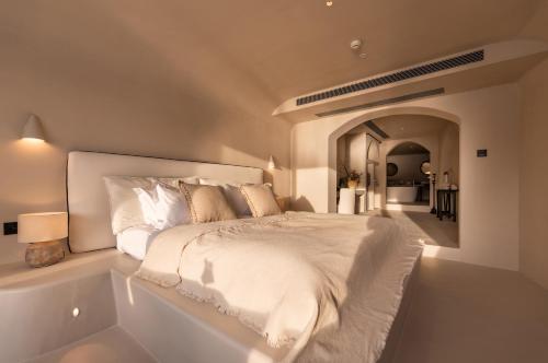 a white bedroom with a bed and a bath tub at 大理松云悬崖酒店 in Dali Ancient Town