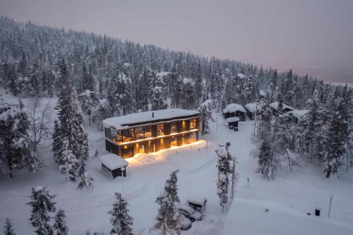 a house in the middle of a snow covered forest at maja in Syöte