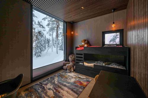 a bedroom with a large window and a tv at maja in Syöte