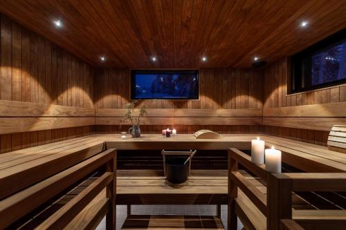 a sauna with two candles and a tv in it at maja in Syöte