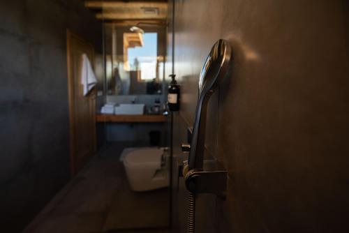 a bathroom door with a toilet and a sink at The Rihla Hunza - Managed By Luxus in Hunza