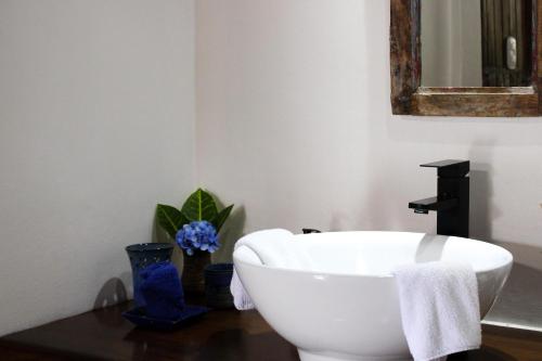 a bathroom with a white bath tub and a sink at Sueño Río Celeste Boutique B&B in Bijagua