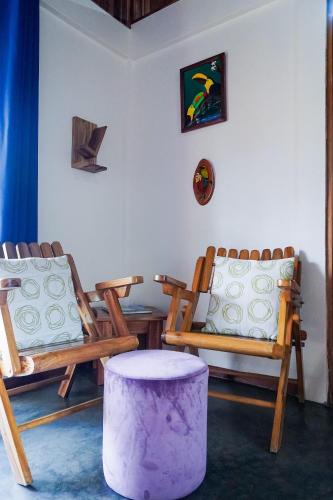 a room with two chairs and a purple stool at Sueño Río Celeste Boutique B&B in Bijagua
