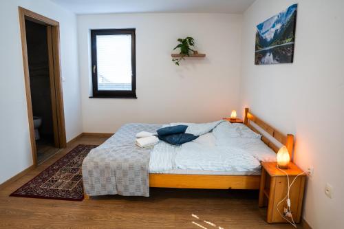 a bedroom with a bed and a table and a window at Adventure Farm in Štore