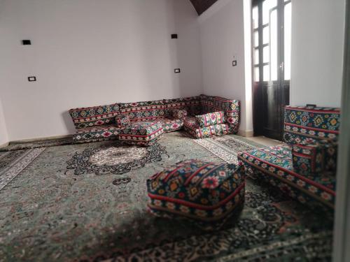 a living room with a couch and chairs in a room at Mena Palace Nile View in Luxor