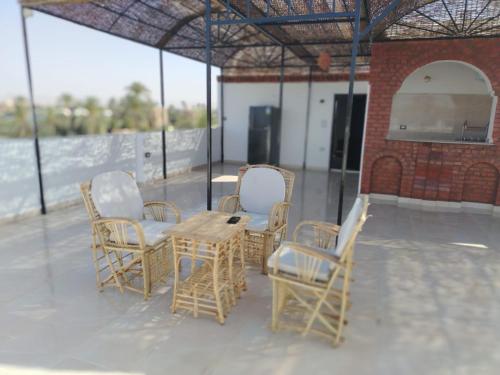 a group of chairs and a table on a patio at Mena Palace Nile View in Luxor
