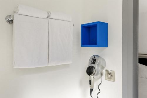 a room with a hair dryer on a wall at ibis Styles Paris République Le Marais in Paris