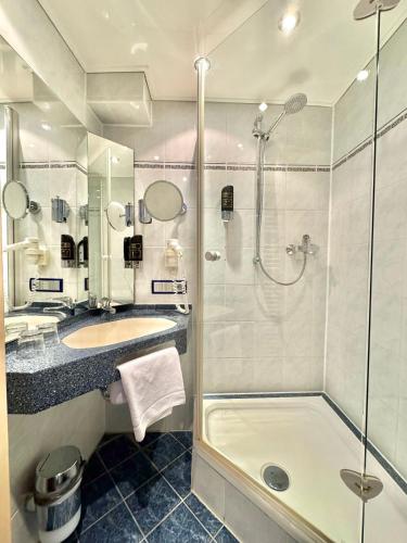 a bathroom with a shower and a sink at AR Boutique Hotel Mannheim in Mannheim